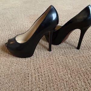 Black. 5 inch heel,peek a boo toe pumps. Never worn!
